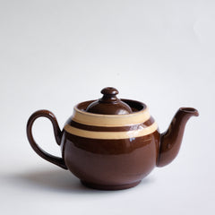 A charming little vintage Brown Betty teapot with two cream coloured bands.