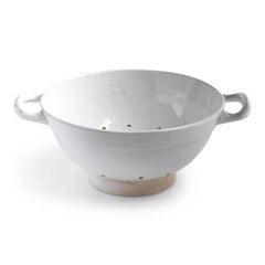 A rare antique Dutch ironstone colander, with twin handles and foot made by Petrus Regouta & Co Maastricht - and stamped with the factory's nineteenth century sphinx logo to its underside.