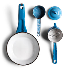 A miniature white speckled blue enamel saucepan with blue lid; a large frying pan; and a long-handled sieve. Part of an extensive antique and vintage collection of miniature pale blue enamel kitchen ware, previously owned by the miniaturist specialist and collector extraordinaire Joan Dunk.