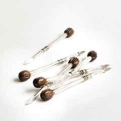 A rare set of 1930s silver-plated nut picks designed to wheedle out every last nugget of flesh from a walnut shell - always the difficult nut to dissect. They have a wonderful weight and beautifully turned, polished handles with a miniature walnut modelled in wood at the end of each.