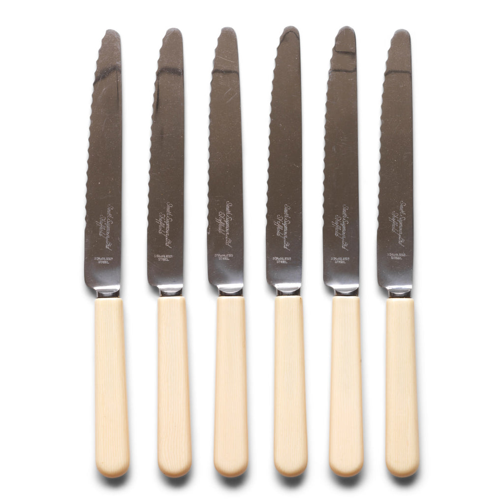 A set of 6 vintage ‘bone-handled’ serrated steak knives each marked Smith Seymour Ltd, Sheffield.