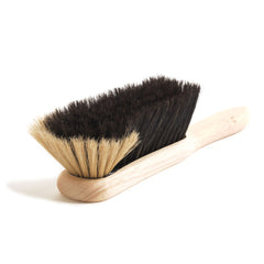 A traditional bannister brush, also known as a dustpan brush, and handmade in the UK by one of our last surviving brush makers. Crafted from beechwood and two-tone horsehair, the splayed bristles are designed to coax dirt from awkward spaces.