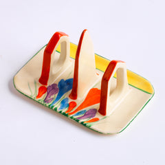 Original 1920s Clarice Cliff Autumn Crocus toast rack for two with good, bright and bold paintwork. The underside is stamped "Hand painted Bizarre by Clarice Cliff Wilkinson Ltd England".