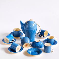 A complete 1930s Art Deco Susie Cooper Blue Crescent Kestrel coffee set decorated with small scarffito crescents, including coffee pot, milk jug, sugar bowl, and six coffee cans and saucers.