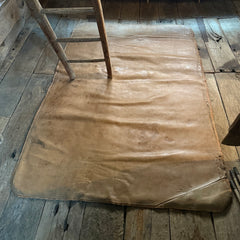 A large soft leather mat with lovely time-worn patina, converted from a 1930s gym mat, shown here in situ at The Tudor House Hastings.