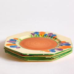 Clarice Cliff early Autumn Crocus octagonal tea plates with vivid paintwork and boldly executed crocuses, and with early hand painted green "Crocus" stamp on the reverse. The underside to each is also stamped "Hand painted Bizarre by Clarice Cliff, Newport Pottery England". 