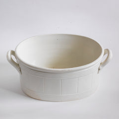 A late 19th century French oval-shaped foot bath with roll-top rim, raised banding, and very elegant handles.