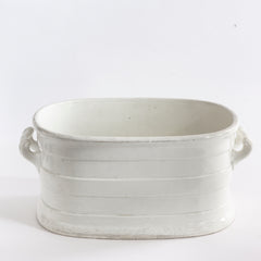 A Victorian oval-shaped foot bath with roll-top rim, raised banding, and up-scrolled handles. It has a good plinth shaped base, has a lovely weight and is in great condition.