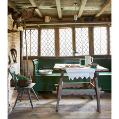 A late 19th century Romanian box bench with its original green painted finish, and a hinged seat that opens to reveal ample storage. It has a panelled back, and its twin arms are supported by turned spindles.