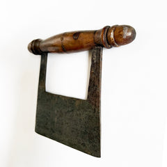 A Victorian kitchen herb chopper or dough scoop that has  a turned beechwood handle and carbon steel blade.