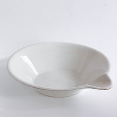 A super-large Victorian ironstone dairy pouring bowl by the "Dairy Supply Company London" (stamp applied to underside) with a rolled rim and a particularly striking pouring lip.