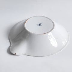 Underside of an s arge Victorian ironstone dairy pouring bowl by the "Dairy Supply Company London" (stamp applied to underside) with a rolled rim and a particularly striking pouring lip.