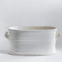 A Victorian oval-shaped foot bath with roll-top rim, raised banding, and up-scrolled handles. It has a good plinth shaped base, has a lovely weight and is in great condition.