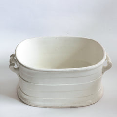 A Victorian oval-shaped foot bath with roll-top rim, raised banding, and up-scrolled handles. It has a good plinth shaped base, has a lovely weight and is in great condition.