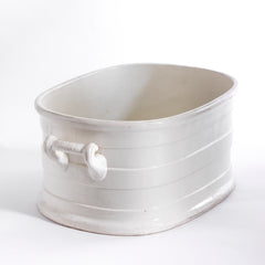 A Victorian oval-shaped foot bath with roll-top rim, raised banding, and up-scrolled handles. It has a good plinth shaped base, has a lovely weight and is in great condition.