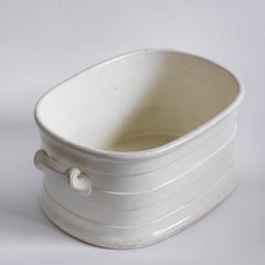 A Victorian oval-shaped foot bath with roll-top rim, raised banding, and up-scrolled handles. It has a good plinth shaped base, has a lovely weight and is in great condition.