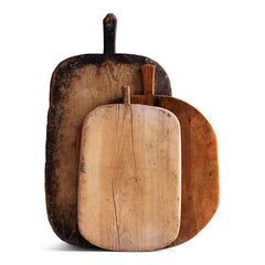 A wonderful collection of antique and vintage bread boards. Their time-worn, knife-cut surfaces are full of character and warmth. They also make excellent communal serving platters for air dried ham, antipasto, breads, cheeses, and pickles; and when not in use, look great as a backdrop when propped up on the kitchen side.