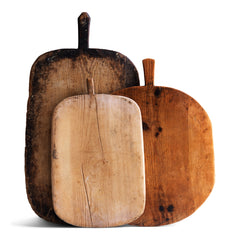 A wonderful collection of antique and vintage bread boards. Their time-worn, knife-cut surfaces are full of character and warmth. They also make excellent communal serving platters for air dried ham, antipasto, breads, cheeses, and pickles; and when not in use, look great as a backdrop when propped up on the kitchen side.