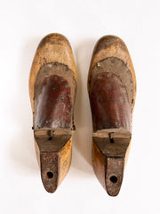A good pair of antique late nineteenth century polished wooden shoe lasts with leather uppers and steel soles.