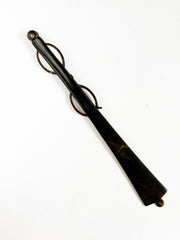 An Edwardian faux tortoiseshell lorgnette - an elegant  pair of fine oval spectacles attached to a long arm in  mock tortoiseshell.