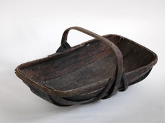 An extra-large rustic antique trug, with a particularly pleasing historic sheet-metal repair to its interior, and a lovely patina formed from decades of use.