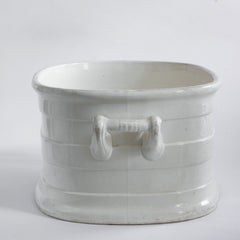 A Victorian oval-shaped foot bath with roll-top rim, raised banding, and up-scrolled handles. It has a good plinth shaped base, has a lovely weight and is in great condition.