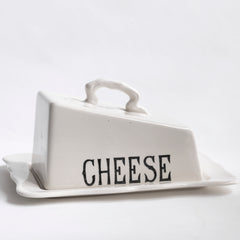 A generously sized 1920s Masons ironstone cheese dish consisting of base plate and cover, the cover with graphic black typeface "Cheese". Underneath the base plate reads "Masons Patent Ironstone England Guaranteed Permanent Acid Resisting Colours".