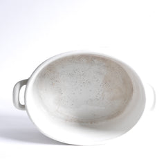 Inside view of a late 19th century French oval-shaped foot bath with roll-top rim, raised banding, and very elegant handles.