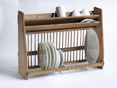 A good Edwardian scrubbed pine plate draining rack which can either be surface stood or wall mounted. Beautifully constructed, it is fitted with a full set of plate dividing spindles. Cups, mugs and bowls can be put to drain upside down on its top shelf, and it accommodates modern-day large dinner plates comfortably. It holds up to 24 large plates, and has a handy narrow upper shelf for saucers and pan lids.