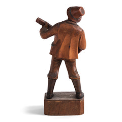 An early twentieth century carved wooden figure of a jovial musician playing a guitar, most likely from Bavaria or the Black Forest, Germany. 