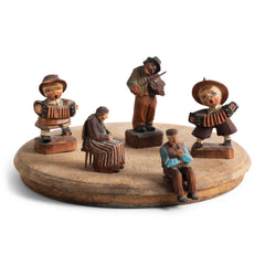 Collection of vintage Bavarian carved wooden musicians, including a pair of boys with accordions, a violinist, and further folk art naive carved figures. 