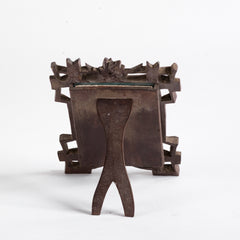 A finely carved late nineteenth century Black Forest tabletop photo frame with a hinged back, the frame of entwined rustic branches with vine leaf decoration. 