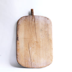 An antique bread board with a pale scrubbed surface, full of character and warmth.  A perfect communal serving platter for air dried ham, antipasto, breads, cheeses, and pickles; and when not in use, looks great as a backdrop when propped up on the kitchen side. 