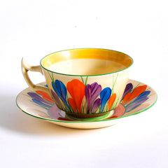 Clarice Cliff early Autumn Crocus Athens cup and saucer with vivid paintwork and boldly executed crocuses, and with early hand painted green "Crocus" stamp on the underside along with "Hand painted Bizarre by Clarice Cliff, Newport Pottery England". 