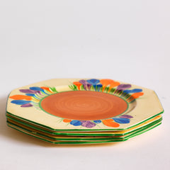 Clarice Cliff early Autumn Crocus octagonal tea plates with vivid paintwork and boldly executed crocuses, and with early hand painted green "Crocus" stamp on the reverse. The underside to each is also stamped "Hand painted Bizarre by Clarice Cliff, Newport Pottery England". 