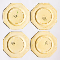The reverse side of four Clarice Cliff early Autumn Crocus octagonal tea plates with vivid paintwork and boldly executed crocuses, showing early hand painted green "Crocus",  and "Hand painted Bizarre by Clarice Cliff, Newport Pottery England". 