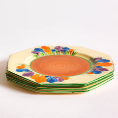 Clarice Cliff early Autumn Crocus octagonal tea plates with vivid paintwork and boldly executed crocuses, and with early hand painted green "Crocus" stamp on the reverse. The underside to each is also stamped "Hand painted Bizarre by Clarice Cliff, Newport Pottery England". 