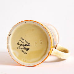 An original 1929 Clarice Cliff Orange Trees & House pattern Athens shape jug with brilliant, bright paintwork. This image shows the  underside, which is stamped Fantasque Hand Painted Bizarre by Clarice Cliff Newport Pottery England. 