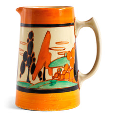 An original 1929 Clarice Cliff Orange Trees & House pattern Athens shape jug with brilliant, bright paintwork. The underside is stamped Fantasque Hand Painted Bizarre by Clarice Cliff Newport Pottery England. 