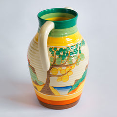 An original 1930s Clarice Cliff twin handle lotus jug in the Secrets pattern, this image showing the side view. The underside is stamped "Fantasque Hand Painted Bizarre by Clarice Cliff Newport Pottery England", and it's a good early one, dating to 1933; and better still, it is beautifully hand painted and in immaculate condition.