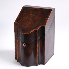 A George III mahogany veneered knife box with an elegant star inlay on the slope of its lid. The serpentine front is banded in satinwood, and it has a compass star decoration with rope cross-banded inlay applied to the underside of its lid - with a silver shield-shaped escutcheon to the lock on the front. 