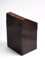 A George III mahogany veneered knife box with an elegant star inlay on the slope of its lid. The serpentine front is banded in satinwood, and it has a compass star decoration with rope cross-banded inlay applied to the underside of its lid - with a silver shield-shaped escutcheon to the lock on the front. 