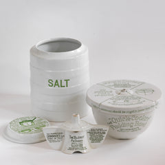 A collection three 1920s ironstone kitchenware ceramics by Grimwades Ltd: a salt jar, a Quick Cooker pudding bowl, and a Bleriot pie divider.