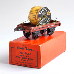 A 1940s Hornby Trains 0-gauge series low sided wagon with cable drum, with striking typography "LEC Liverpool Cables" decorating both sides of the cable drum. It comes with its original box, and is in great condition.