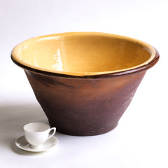 A late nineteenth century bread proving bowl with a honey coloured glazed interior, burnt biscuit exterior, and a deep rolled rim. 