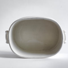 A Victorian oval-shaped foot bath with roll-top rim, raised banding, and up-scrolled handles. It has a good plinth shaped base, has a lovely weight and is in great condition.