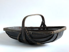 An extra-large rustic antique trug, with a particularly pleasing historic sheet-metal repair to its interior, and a lovely patina formed from decades of use.