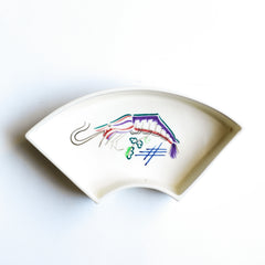 Part of a mid century vintage Poole Pottery seafood hors d'oeuvre set consisting of five ceramic dishes that fit snugly into a circular wooden tray. Each crescent shaped dish is decorated with a hand painted pattern of a shrimp (as shown here), a flatfish, a crab  and a scallop - designed by Truda Carter and hand painted on Poole Pottery's alpine white glaze. Each piece is stamped to its underside "Handmade Hand Decorated Poole England", along with the paintress's mark.
