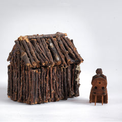 A miniature naive carved wooden figure of a peasant women seated on an Alpine chair, with its original staining and paint - mid century, Bavarian. 