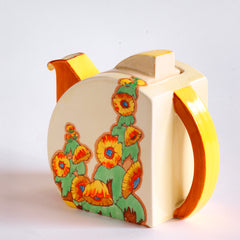 A 1930s original Clarice Cliff Stamford teapot in Sunshine pattern, painted with yellow hollyhocks, and with Bizarre and Sunshine stamped to its underside, and in immaculate condition.